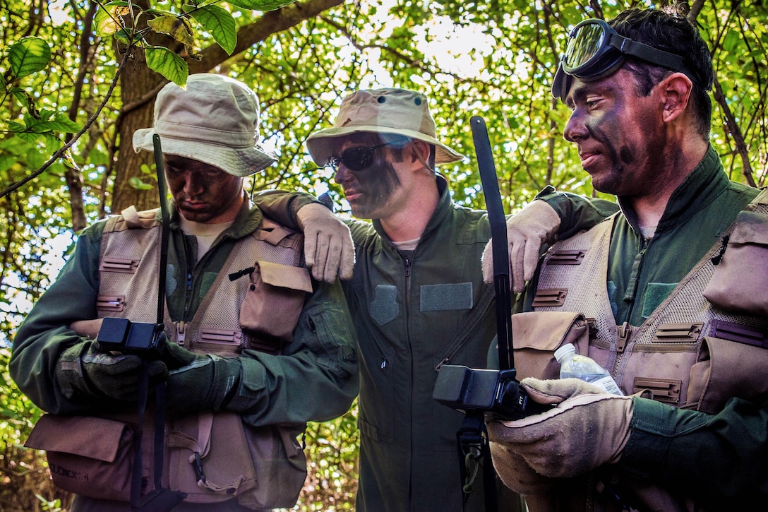 Air Force Senior Airman Cody Harter, Staff Sgt. Jacob King and Senior Airman Steven Sirois learn emergency radio procedures during survival, evasion, resistance and escape training at Rosecrans Air National Guard Base in St. Joseph, Mo., Sept. 29, 2016. Harter, King and Sirois are assigned to the Missouri Air National Guard’s 180th Airlift Squadron. Air Force National Guard photo by Senior Airman Patrick P. Evenson
