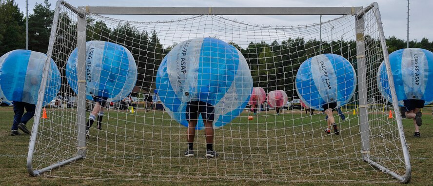 Airmen begin to charge at Soldiers during the kick off for the Combined Federal Campaign-Overseas’ bubble soccer match at Ramstein Air Base, Germany, Sept. 30, 2016. The kick-off match provided Airmen, Soldiers and their families an opportunity to engage with the CFC-O and learn how they can contribute to helping the local community. (U.S. Air force photo by Airman 1st Class Lane T. Plummer)