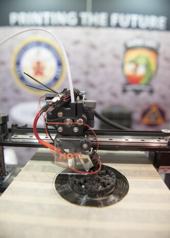 160928-N-IL267-005 QUANTICO, Virginia (Sept. 28, 2016) A 3-D printer additively manufactures a symbol at Modern Day Marine Expo at Marine Corps Base Quantico, Va. The symbol represents Naval Sea Systems Command, Naval Aviation Systems Command, Marine Corps Systems Command, the Marine Corps Warfighting Laboratory, and Marine Corps Headquarters, Installations and Logistics Department, all of which collaborated on an additive manufacturing parts demonstration at the expo. (U.S. Navy photo by Dustin Q. Diaz/released)

