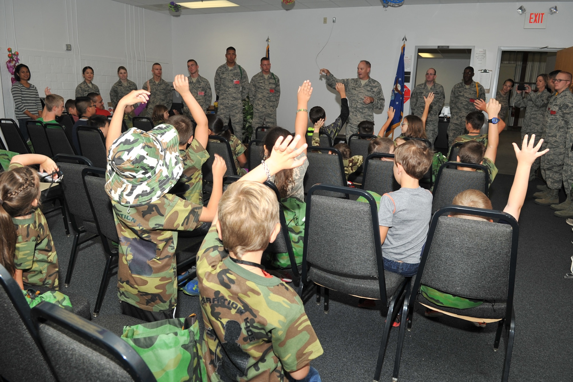 U.S. Air Force Col. Michael Downs, 17th Training Wing Commander, questions children before they go on a mock deployment during Operation Kids Investigating Deployment Services at the Vance Deployment Center, Goodfellow Air Force Base, Texas, Oct. 1, 2016. Operation KIDS is an annual event designed to introduce military children to deployment operations that their parents may experience. (U.S. Air Force photo by Staff Sgt. Laura R. McFarlane/Released)