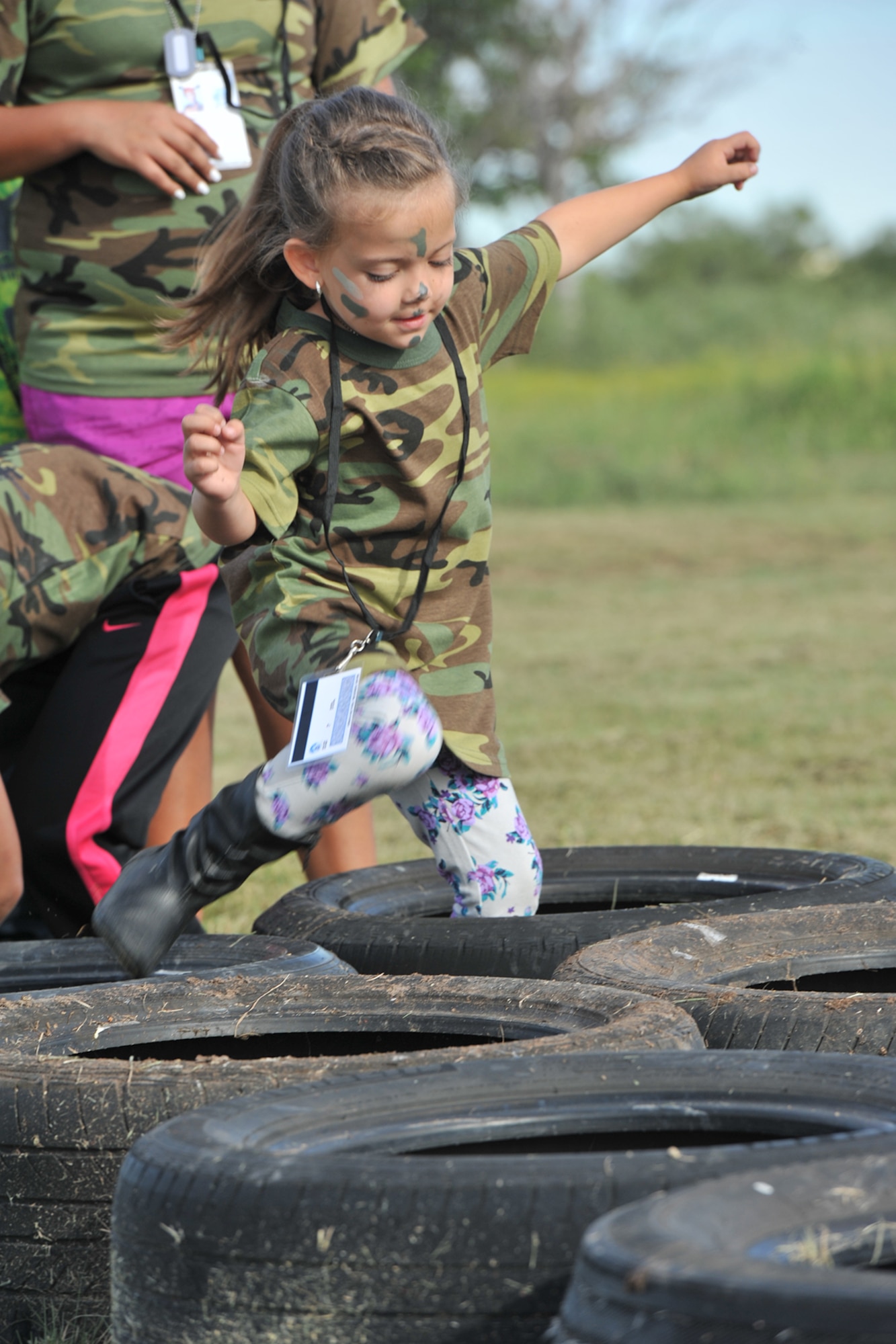 A child runs through tires as part of 17th Security Forces Squadron training during Operation Kids Investigating Deployment Services at the 17th Force Support Squadron Lodge, Goodfellow Air Force Base, Texas, Oct. 1, 2016. The 17th Security Forces Squadron used multiple stations to train the youths for their deployment. (U.S. Air Force photo by Staff Sgt. Laura R. McFarlane/Released) 