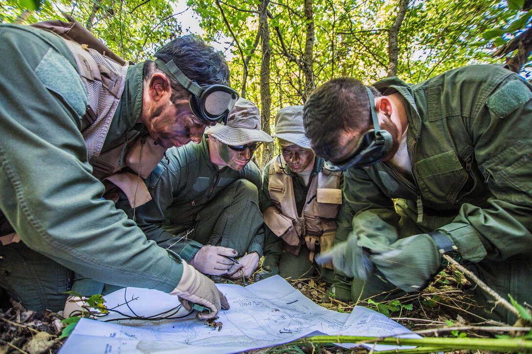 Air Force Senior Airman Steven Sirois, Staff Sgt. Jacob King, Senior Airman Cody Harter and Tech. Sgt. Taylor Schoen plot a course to an extraction point during survival, evasion, resistance and escape training at Rosecrans Air National Guard Base in St. Joseph, Mo., Sept. 29, 2016. Sirois, King, Harter and Schoen are assigned to the Missouri Air National Guard’s 180th Airlift Squadron. Air Force National Guard photo by Senior Airman Patrick P. Evenson