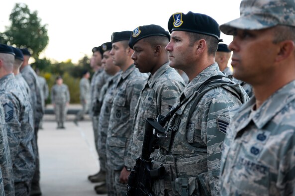50th Security Forces Squadron members listen as the name of a fallen defender is read during a ceremony at Schriever Air Force Base, Colorado, Wednesday, Sept. 28, 2016. Prior to reveille, each 50 SFS squad leader would state any missing members as they reported their squad present. Another defender would then come forward to read a short biography, including how and where the fallen defender was killed in action. The ceremony honored the six 50 SFS defenders killed in September and October.  (U.S. Air Force photo/Christopher DeWitt)
