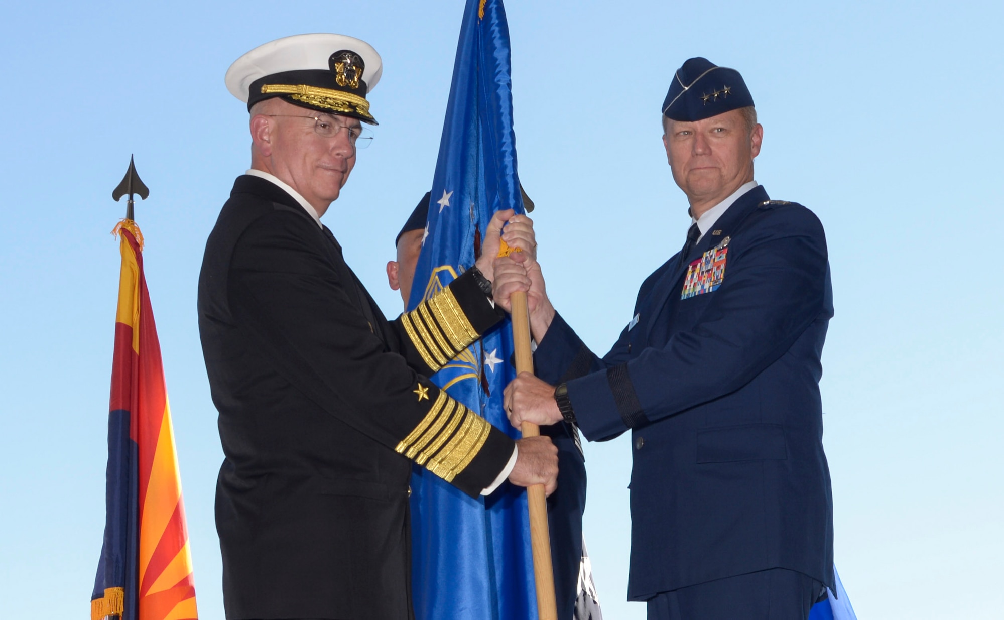 Adm. Kurt Tidd, commander of U.S. Southern Command, passes the Twelfth Air Force (Air Forces Southern) flag to Lt. Gen. Mark Kelly, commander of Twelfth Air Force (Air Forces Southern), during the a change of command ceremony Oct. 3, 2016, at Davis-Monthan Air Force Base, Ariz. During the ceremony Lt. Gen. Chris Nowland relinquished command to Lt. Gen. Mark Kelly. Air Forces Southern serves as the air component to U.S. Southern Command and is responsible for providing air and space capabilities in support of U.S. military partnerships across Central and South America, and the Caribbean. (U.S. Air Force photo by Tech. Sgt. Heather Redman)