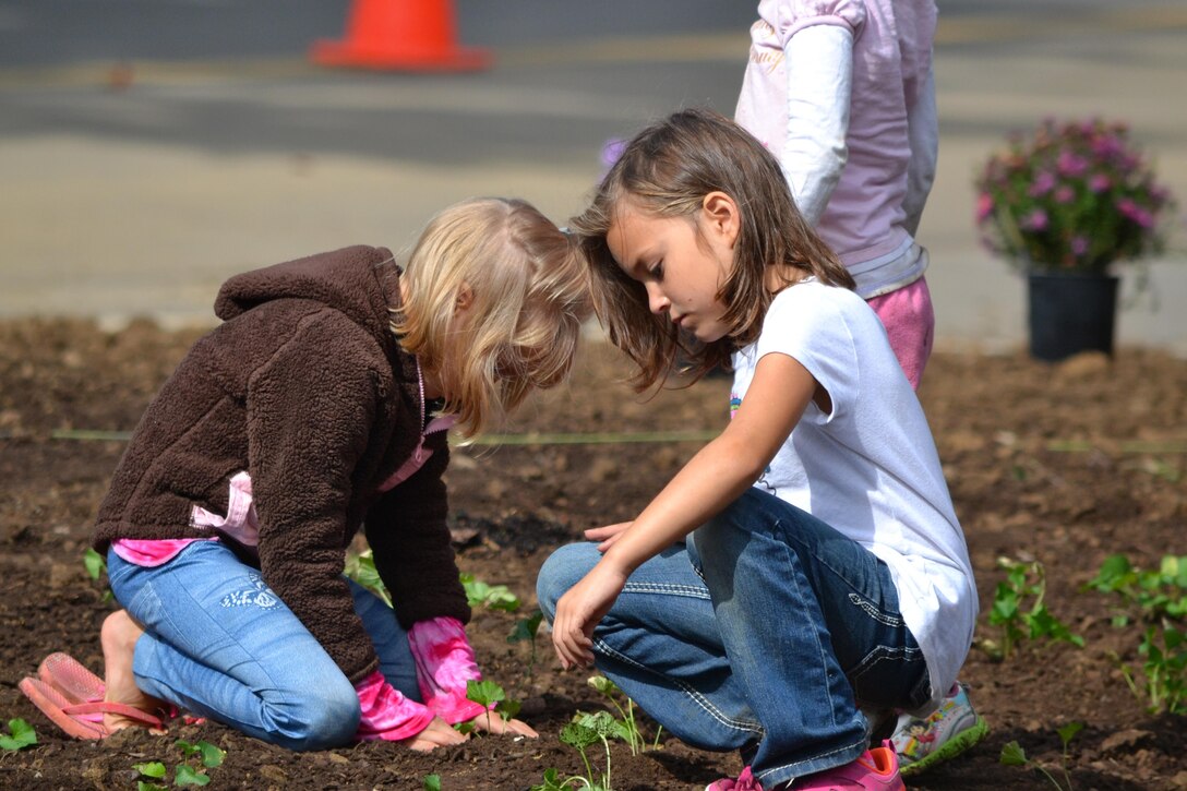 Two young girls work in a garden bed at the Cheatham Lake Resource Manager's Office during a National Public Lands Day event Oct. 1, 2016. Cheatham County Master Gardeners orchestrated planting bee-and-butterfly-friendly plants.