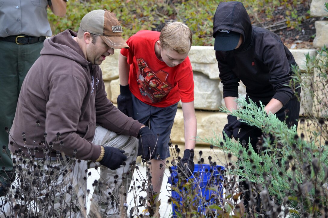 Volunteers remove dead plants from a garden bed at the Cheatham Lake Resource Manager's Office during a National Public Lands Day event Oct. 1, 2016. Cheatham County Master Gardeners orchestrated planting bee-and-butterfly-friendly plants.