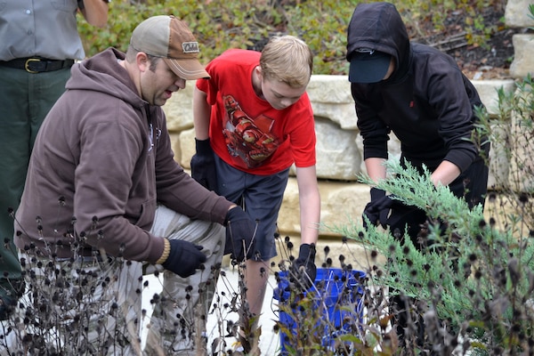 Volunteers remove dead plants from a garden bed at the Cheatham Lake Resource Manager's Office during a National Public Lands Day event Oct. 1, 2016. Cheatham County Master Gardeners orchestrated planting bee-and-butterfly-friendly plants.