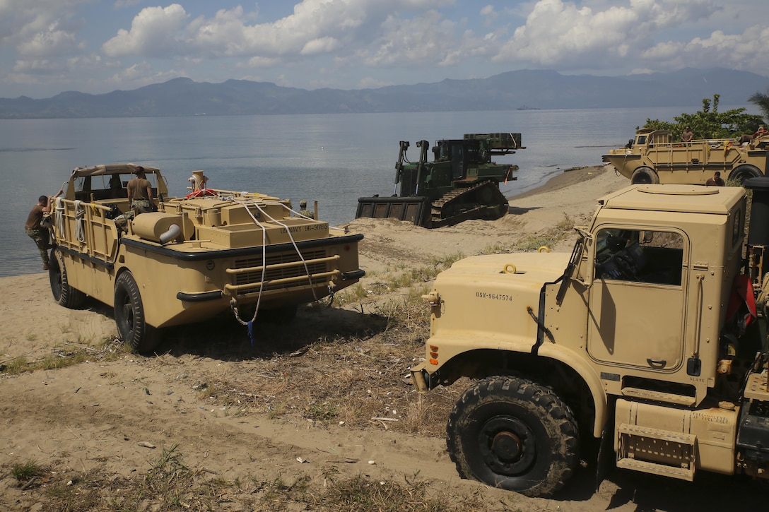 Marines with Special Purpose Marine Air-Ground Task Force Southern Command and sailors with the USS Oak Hill disembark gear and vehicles at Puerto Castilla, Honduras, June 15, 2016. The Marines and sailors unloaded all their vehicles and gear necessary for construction projects in Honduras with the assistance of the Honduran military. U.S. Marines and sailors assigned to the task force participated in engineering projects, security cooperation and disaster relief preparation in Belize, El Salvador, Guatemala and Honduras. Marine Corps photo by Cpl. Ian Ferro