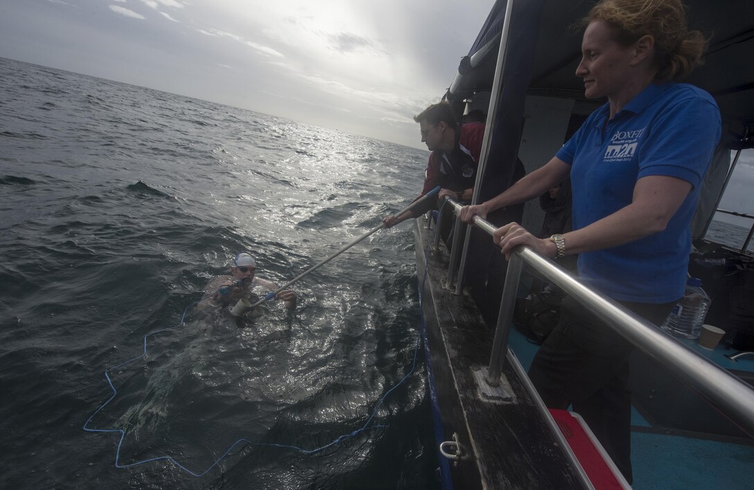 Maj. Casey Bowen (left), a dermatologist with the 59th Medical Wing, drinks some liquid as he swims across the English Channel Sept. 26, 2016. Bowen successfully swam from the shoreline of Dover, England, to the French coast, and completing his swim across the channel. (DoD News photo/Tech. Sgt. Brian Kimball)