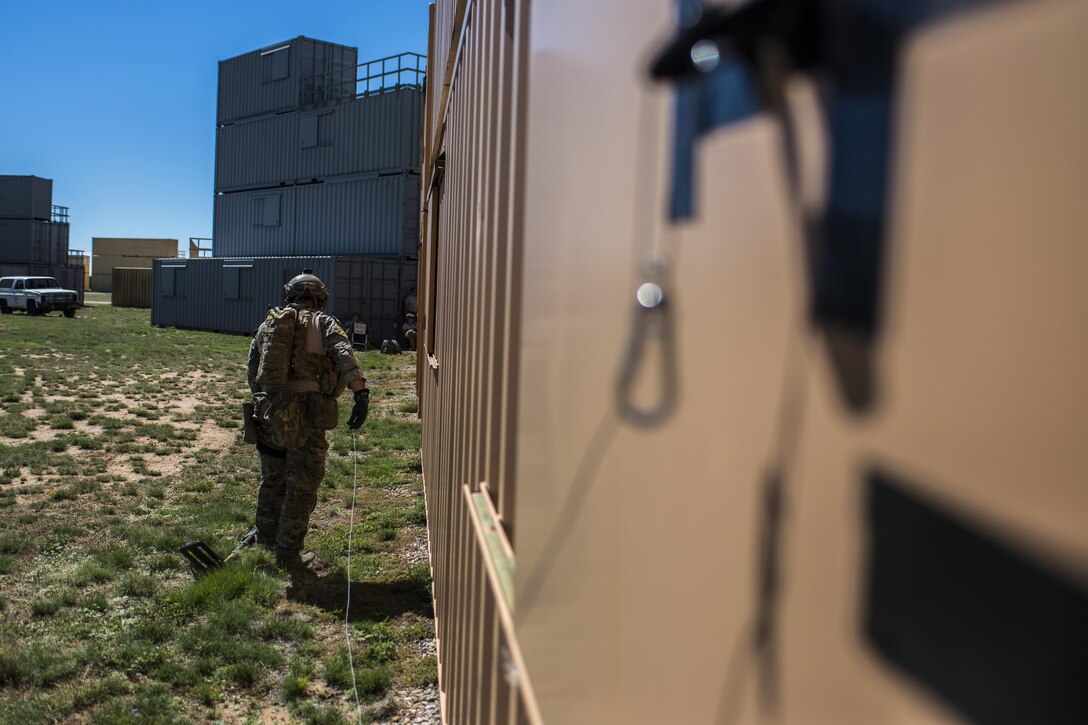 A member of the 27th Special Operations Civil Engineer Squadron Explosive Ordnance Disposal flight uses his equipment to open a window during improvised explosive device training at Melrose Air Force Range, N.M., Sept. 28, 2016. The flight conducted more than five different scenarios which they could possibly encounter in a deployed environment. (U.S. Air Force photo by Senior Airman Luke Kitterman/Released)