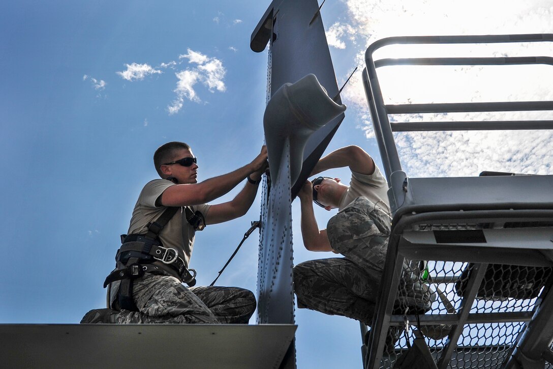 Air Force Staff Sgt. Jonathan Knutson, left, and Airman 1st Class Curtis Masenheimer perform maintenance on the tail of a CV-22 Osprey at Hurlburt Field, Fla., Sept. 27, 2016. Knutson and Masenheimer are crew chiefs assigned to the 801st Special Operations Aircraft Maintenance Squadron. Air Force photo by Airman 1st Class Joseph Pick