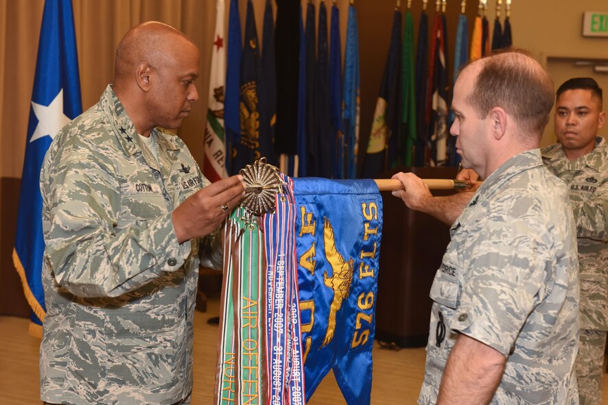 Maj. Gen. Anthony Cotton, 20th Air Force commander and Col. Craig Ramsey, 576th Flight Test Squadron commander, unravel the new 576th FLTS flag during a realignment ceremony, Sept. 30, 2016, Vandenberg Air Force Base, Calif. The Air Force Global Strike Command Operations Directorate transferred administrative control of the 576th FLTS to the 20th AF commander, effective Oct. 1. (U.S. Air Force photo by Airman 1st Class Robert J. Volio/Released)