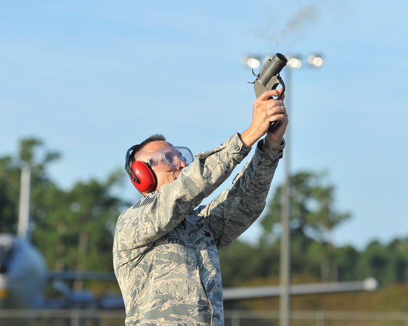 U.S. Air Force Chief Master Sgt. Todd Petzel, 18th Air Force command chief, fires a flare gun Sept. 28, 2016, at Joint Base Charleston, South Carolina during his visit to the 437th Operations Support Squadron. Members of the base’s Bird/Animal Aircraft Strike Hazard program uses flare guns to frighten birds away from the flight line. Bird strikes can cause millions of dollars in fuselage and engine damage and even the total loss of an aircraft.