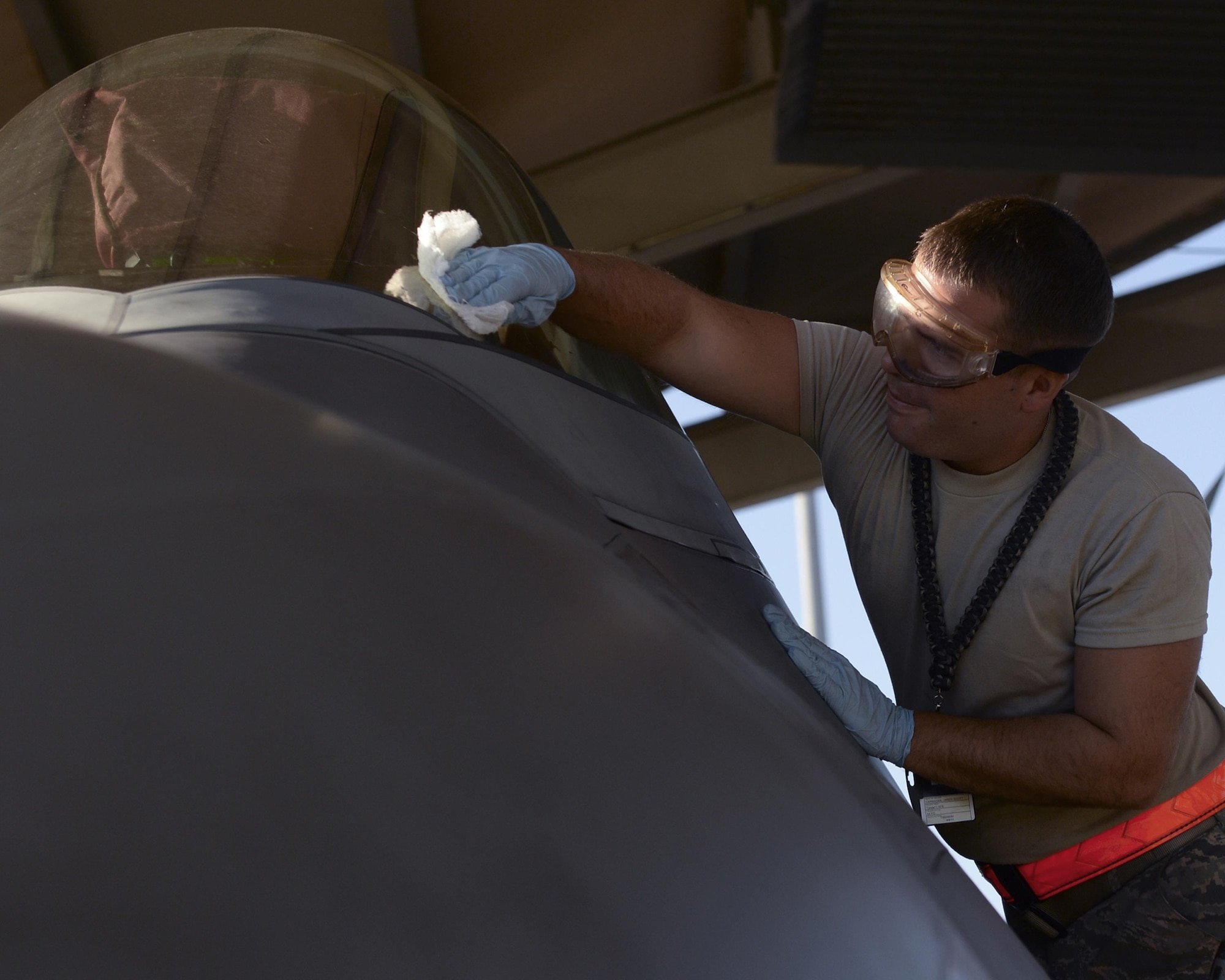U.S. Air Force Senior Airman Jared Carnahan, 44th Fighter Group crew chief, cleans the windshield of an F-22 Raptor on the flightline at Tyndall Air Force Base, Fla., Sept. 10, 2016. In addition to maintaining and repairing the F-22, crew chiefs at Tyndall also ensure the jet is in perfect condition before the pilot enters the jet. The 44th FG accomplishes total force integration by providing pilots, maintainers and support personnel in partnership with the 325th Fighter Wing to execute the Tyndall mission to train and project unrivaled combat air power. (U.S. Air Force photo by Airman 1st Class Cody R. Miller/Released)