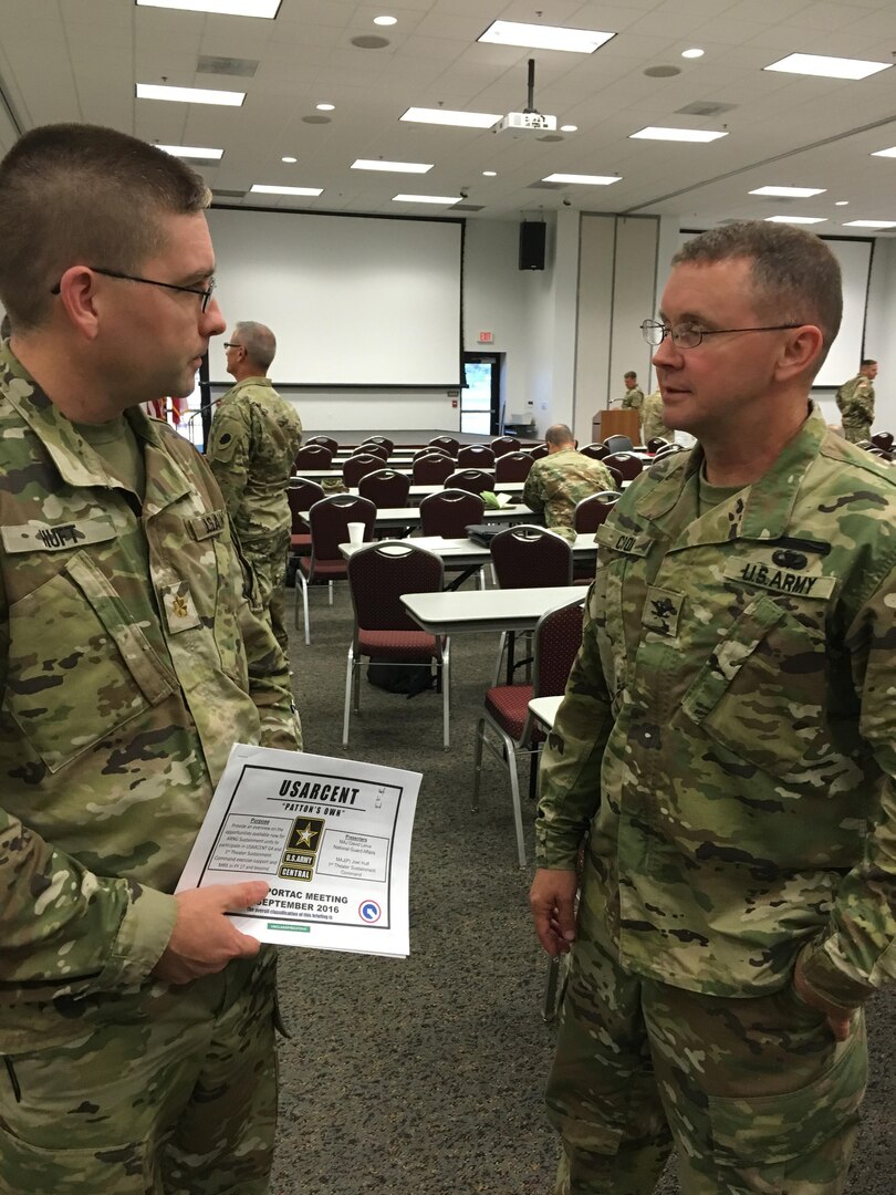 Maj. Joel Huft, left, chief exercise planner for the Fort Bragg, N.C.-based 1st Theater Sustainment Command, discusses details of sustainment training exercises available through 1st TSC with Col. Reginald Cook, the deputy chief of staff for operations and training at the Georgia Army National Guard. Huft, a member of the active component, was invited by Cook to address the Army National Guard’s Plans, Operations, Readiness, Training Advisory Council, or PORTAC, during its semi-annual meeting on Sept. 19 in Savannah, Ga. Cook is the national chairman of the group that represents the Army Guard in 54 States and Territories. 