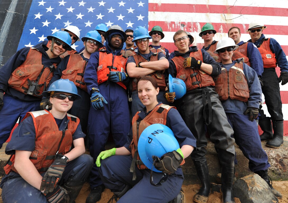 BALTIMORE – Crewmembers from the Coast Guard Cutter Sledge and James Rankin, both based out of Baltimore, pose for a group picture during their Earth Day project to clean up the shore in Curtis Bay, Md., April 21, 2011. The two ships sent volunteers from each crew to assist in the clean up efforts to improve the environment. U.S. Coast Guard photos by Petty Officer 3rd Class Robert Brazzell. 