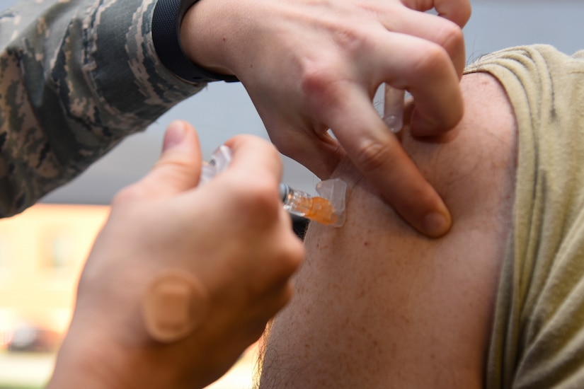 A participant in the Flu Shot Kick-Off gets vaccinated for the influenza virus on Joint Base Andrews, Md., Oct. 3, 2016. A base-wide vaccination drive for retirees, active duty and dependents is scheduled for Oct. 17-18 from 8 a.m. to 4p.m. at the installation theater. (U.S. Air Force photo by Airman 1st Class Valentina Lopez)