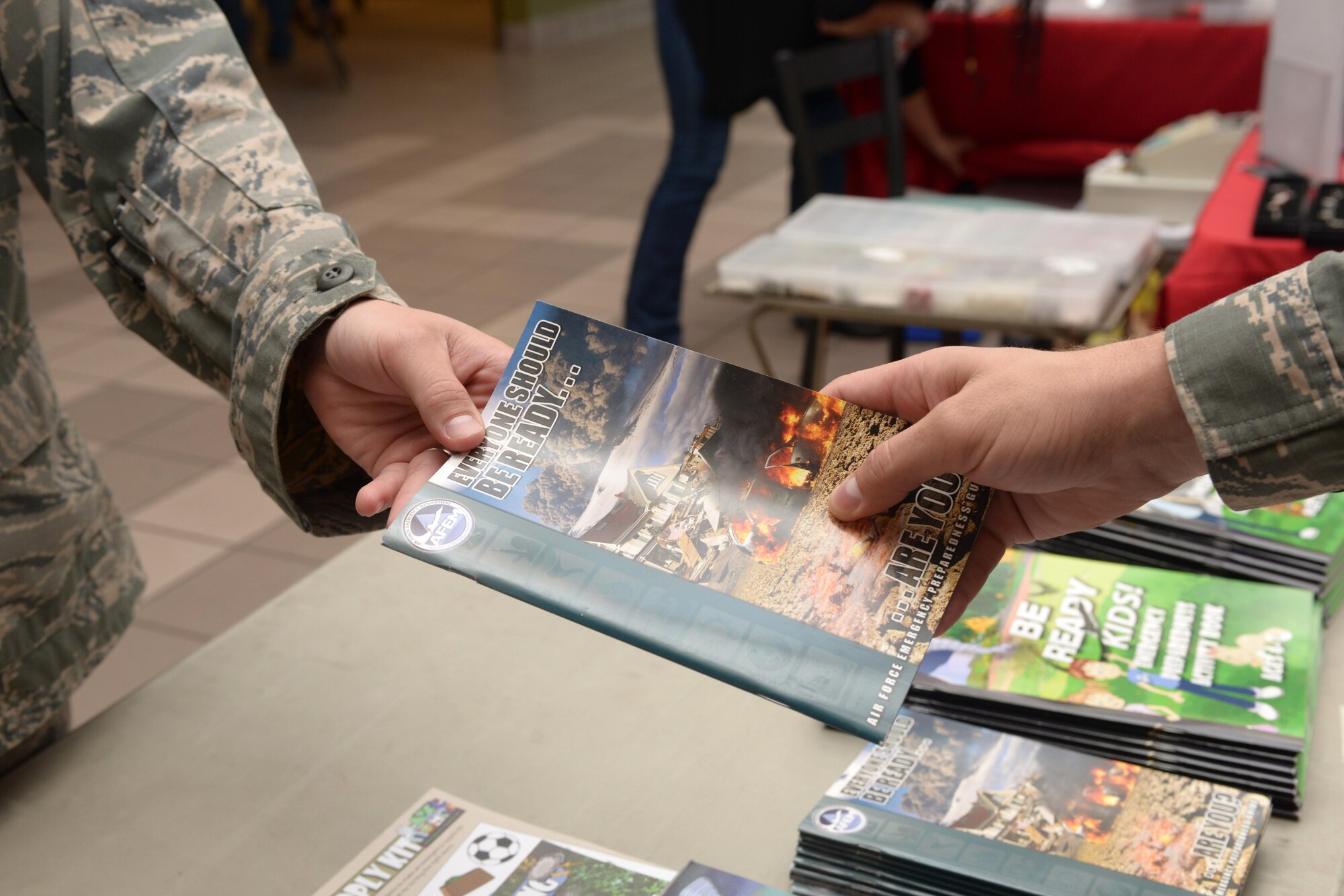 Members of the 28th Civil Engineer Squadron’s emergency management office set up a booth with emergency preparation information in the Base Exchange at Ellsworth Air Force Base, S.D., Sept. 30, 2016. Airmen passed out fliers and pamphlets that gave information on the recommended items needed in various emergency situation, including items such as water and food – at least a three day supply, a flashlight with extra batteries, a first-aid kit and a cell phone with a charger. (U.S. Air Force photo by Airman 1st Class Donald C. Knechtel)