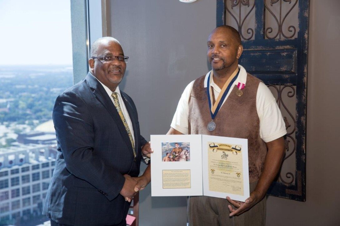 Deputy Director Reginald King presents Willie Key with the Regimental Quartermaster Award