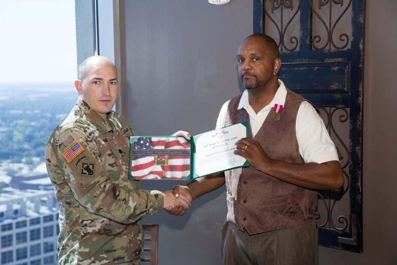 Deputy Commander, Lt. Col. Landon Raby, Mobile District presents Willie Key with coin and retirement award on behalf of Commander, Maj. Gen. Michael Wehr, Mississippi Valley Division.