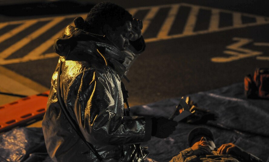 U.S. Air Force Senior Airman Joan Ortega, 8th Civil Engineer Squadron firefighter, wipes sweat off of his forehead while reading information on a paper in a mass casualty exercise during Beverly Pack 17-1 at Kunsan Air Base, Republic of Korea, Oct. 4, 2016.  The U.S. Air Force and Republic of Korea Air Force provide combat capabilities and training by performing exercises throughout the year to enhance communication and interoperability between military forces so they are prepared to fight as a combined force. (U.S. Air Force photo by Senior Airman Colville McFee/Released) 