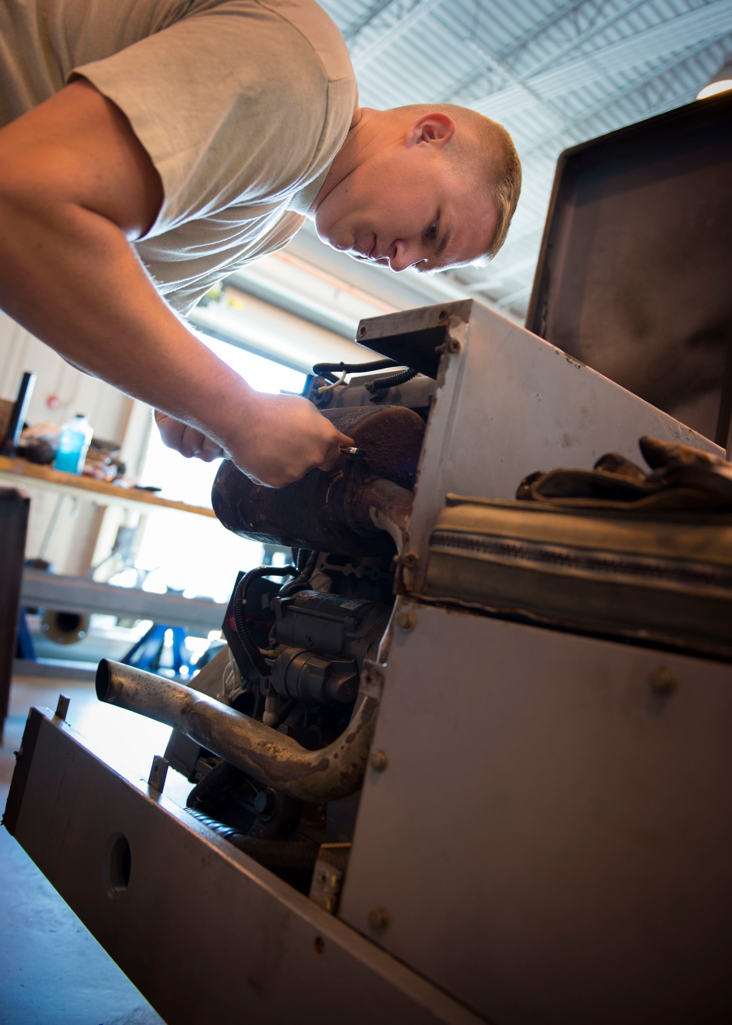 Senior Airman Miles Shepperd, an aerospace ground equipment journeyman with the 1st Special Operations Maintenance Squadron, repairs an exhaust pipe on a munitions handling unit at the AGE hangar on Hurlburt Field, Fla., Oct. 3, 2016. An MHU is used to assist munitions Airmen with transporting and loading ammo onto aircraft. (U.S. Air Force photo by Senior Airman Krystal M. Garrett)