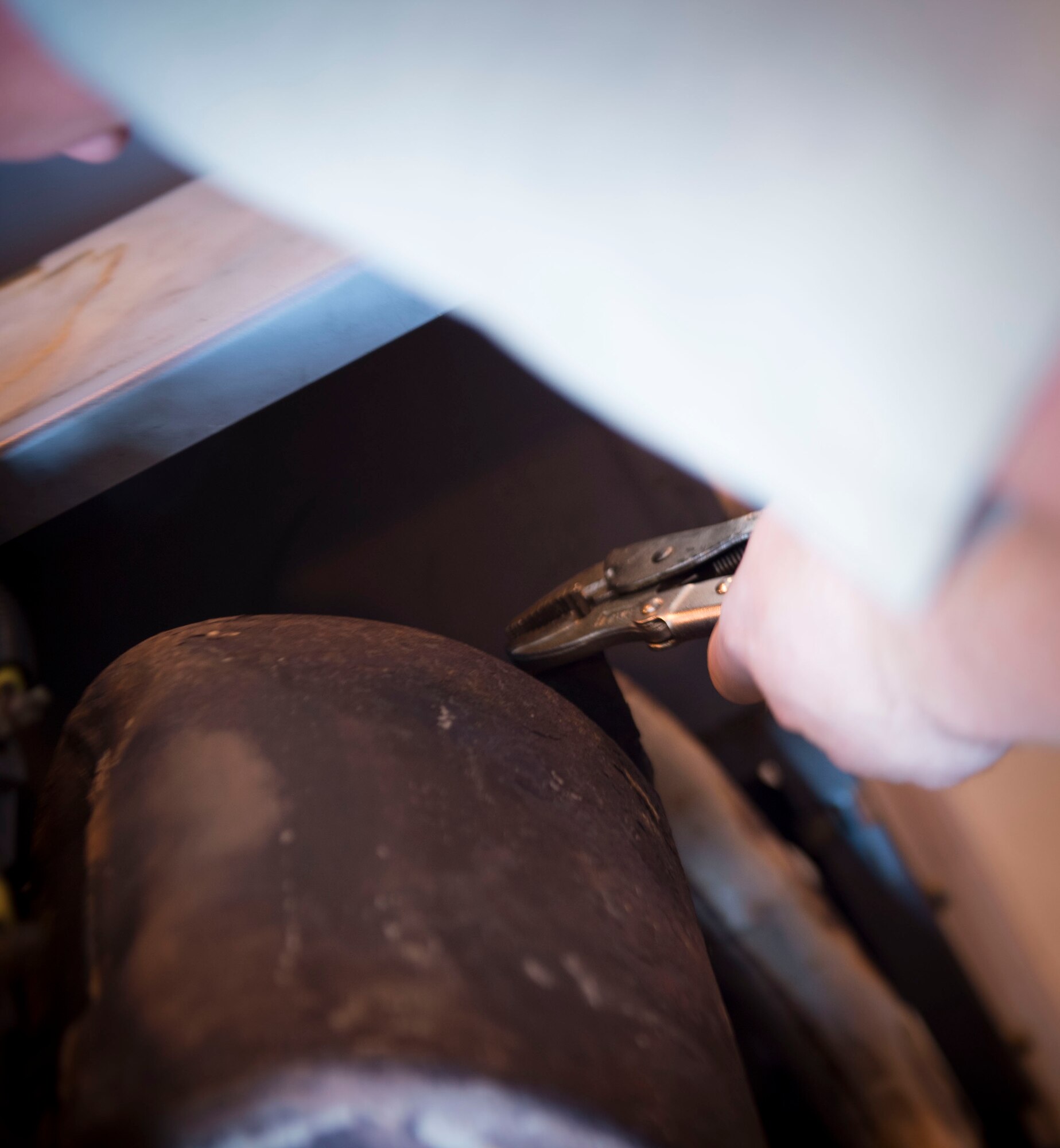 Senior Airman Miles Shepperd, an aerospace ground equipment journeyman with the 1st Special Operations Maintenance Squadron, loosens a bolt on an exhaust pipe to a munitions handling unit at the AGE hangar on Hurlburt Field, Fla., Oct. 3, 2016. The MHU can carry over 6,500 pounds of ammunition. (U.S. Air Force photo by Senior Airman Krystal M. Garrett)