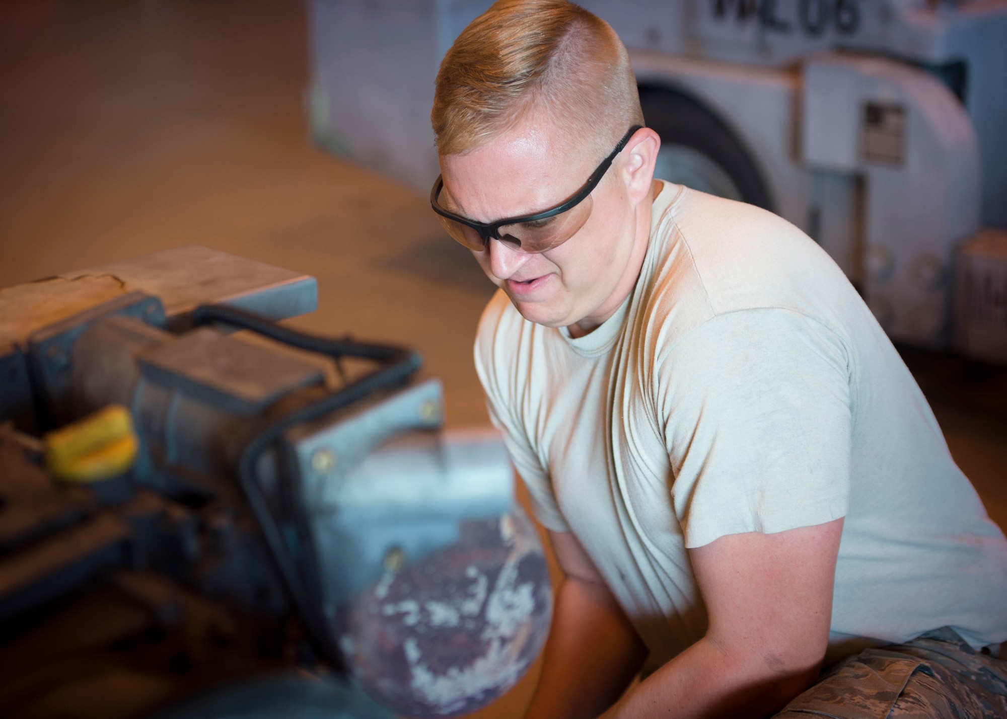 Senior Airman Miles Shepperd, an aerospace ground equipment journeyman with the 1st Special Operations Maintenance Squadron, removes an exhaust pipe from a munitions handling unit at the AGE hangar on Hurlburt Field, Fla., Oct. 3, 2016. The MHU can carry over 6,500 pounds of ammunition. (U.S. Air Force photo by Senior Airman Krystal M. Garrett)