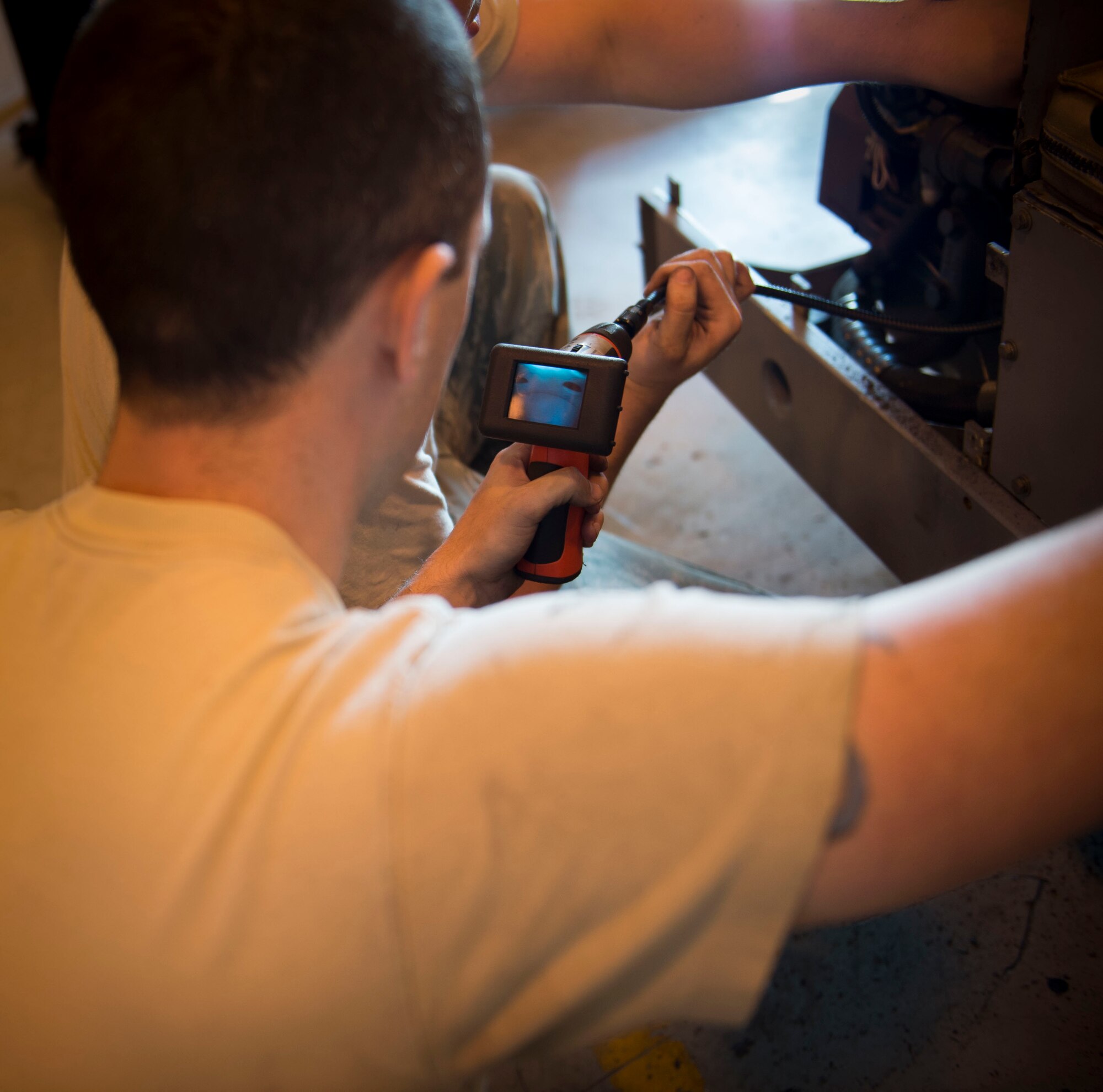 Staff Sgt. Robert Pennington, an aerospace ground equipment craftsman with the 1st Special Operations Maintenance Squadron, uses a scope to look inside a munitions handling unit exhaust pipe at the AGE hangar on Hurlburt Field, Fla. Oct. 3, 2016. An MHU is used to assist munitions Airmen with loading munitions onto aircraft. (U.S. Air Force photo by Senior Airman Krystal M. Garrett)