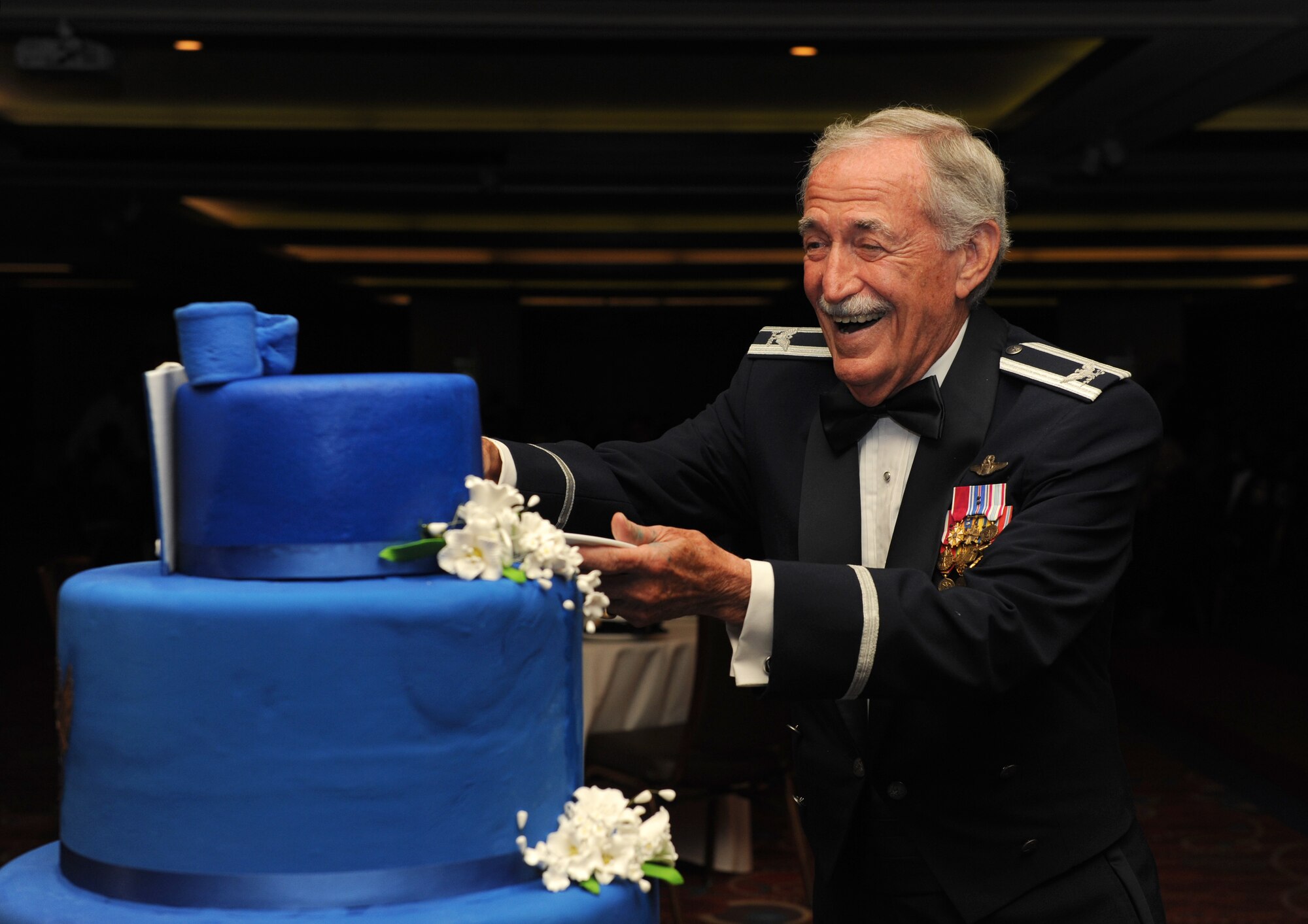 Retired Col. Sid Wright participates in a cake cutting ceremony during the Keesler Air Force Ball at the Imperial Palace Casino Sept. 24, 2016, Biloxi, Miss. Wright was the oldest Airman at the ball; it is tradition for the oldest and youngest Airmen in attendance to cut the cake. The event was sponsored by the Air Force Association John C. Stennis Chapter #332 to celebrate the Air Force’s 69th birthday and the base’s 75th anniversary. (U.S. Air Force photo by Kemberly Groue/Released)