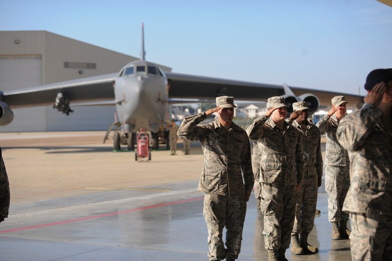 A B-52 Stratofortress sits in the background as Eighth Air Force Airmen salute their new commander during the change of command ceremony at Barksdale Air Force Base, La., Oct. 4 2016. U.S. Air Force Maj. Gen. Thomas Bussiere assumed command from Maj. Gen. Richard Clark, becoming the 53rd commander of The Mighty Eighth. (U.S. Air Force photo by Airman 1st Class Stuart Bright)