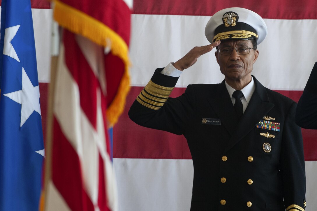 U.S. Navy Admiral Cecil Haney salutes an audience of bomber Airmen during the Joint Functional Component Command for Global Strike and Task Force 204 change of command ceremony at Barksdale Air Force Base, La., Oct. 4, 2016. The JFCC-GS and TF204 commander roles are duties held by the Eighth Air Force commander, who is responsible for all of the Air Force's bombers. U.S. Maj. Gen. Thomas Bussiere assumed command from Maj. Gen. Richard Clark. (U.S. Air Force photo by Senior Airman Joseph Raatz)