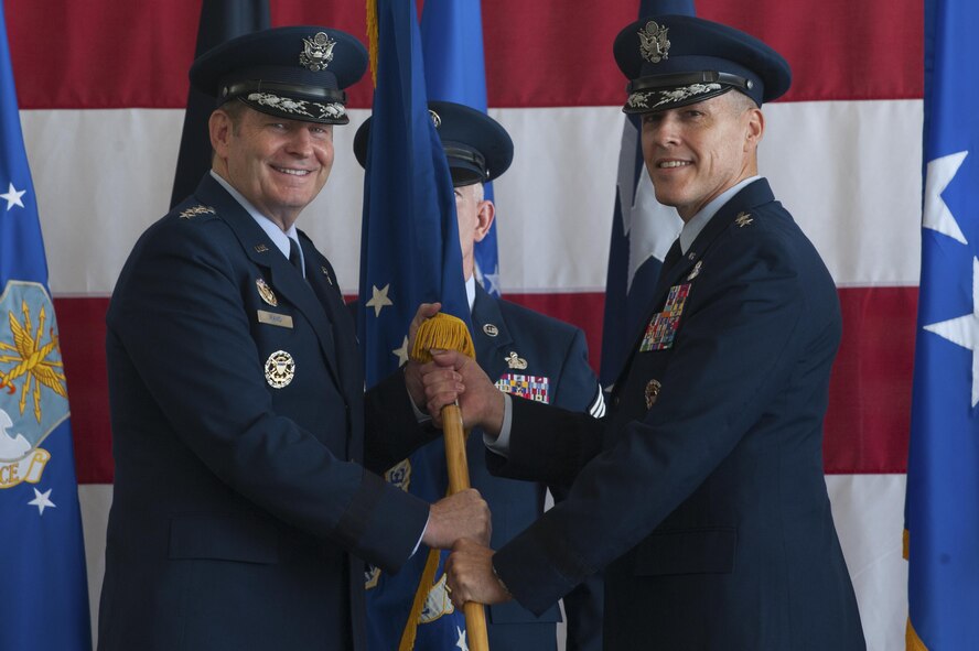 From left, U.S. Air Force Gen. Robin Rand, commander of Air Force Global Strike Command, passes the Eighth Air Force flag to Maj. Gen. Thomas Bussiere signifying the changing of command for The Mighty Eighth. Bussiere is the 53rd commander of the Eighth Air Force and responsible for all of the Service's bomber fleets. (U.S. Air Force photo by Senior Airman Joseph Raatz)