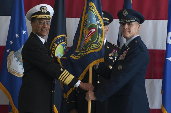From left, U.S. Navy Admiral Cecil Haney, commander of U.S. Strategic Command, passes the Joint Functional Component Command for Global Strike flag to U.S. Air Force Maj. Gen. Thomas Bussiere, the new JFCC-GS commander during a change of command ceremony at Barksdale AFB, La., Oct. 4, 2016. Bussiere is also the Task Force 204 commander, who oversees the Air Force nuclear bomber and reconnaissance activities in support of USSTRATCOM. (U.S. Air Force photo by Senior Airman Joseph Raatz)
