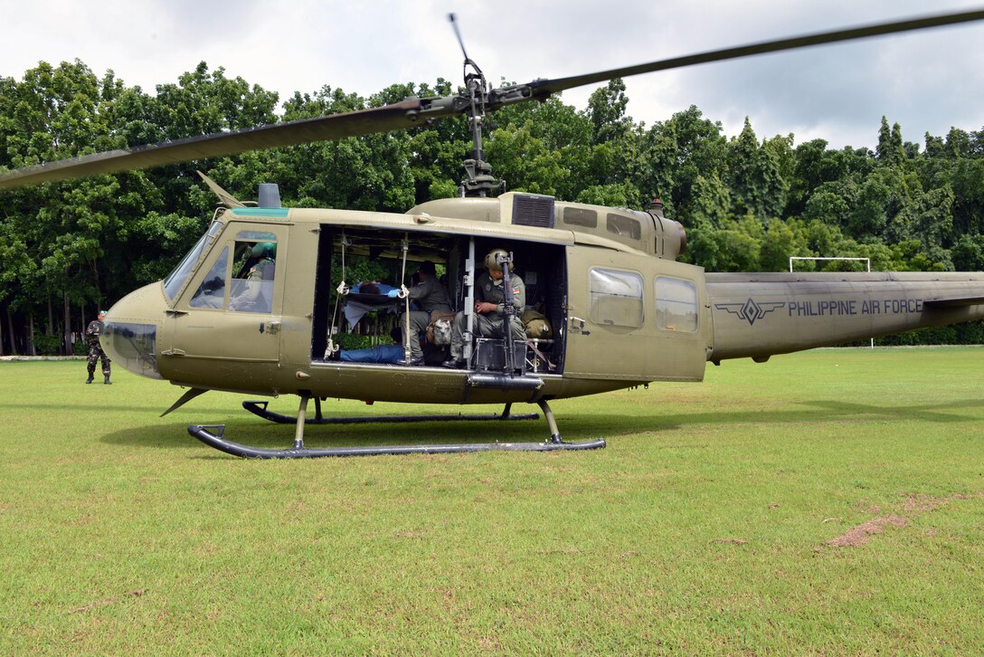 A Philippine Air Force UH-1 prepares to lift off from a simulated incident site during a mass casualty response drill as part of the current iteration of a rotational Air Contingent at Brigadier General Benito N Ebuen Air Base, Philippines Sept. 29, 2016. During the drill, civilian and military disaster response experts met together to exchange ideas and best practices. The Air Contingent is helping build the capacity of the Philippine Air Force and increases joint training, promotes interoperability and provides greater and more transparent air and maritime situational awareness to ensure safety for military and civilian activities in international waters and airspace. Its missions include air and maritime domain awareness, personnel recovery, combating piracy, and assuring access to the air and maritime domains in accordance with international law. (U.S. Air Force photo by Capt. Mark Lazane)