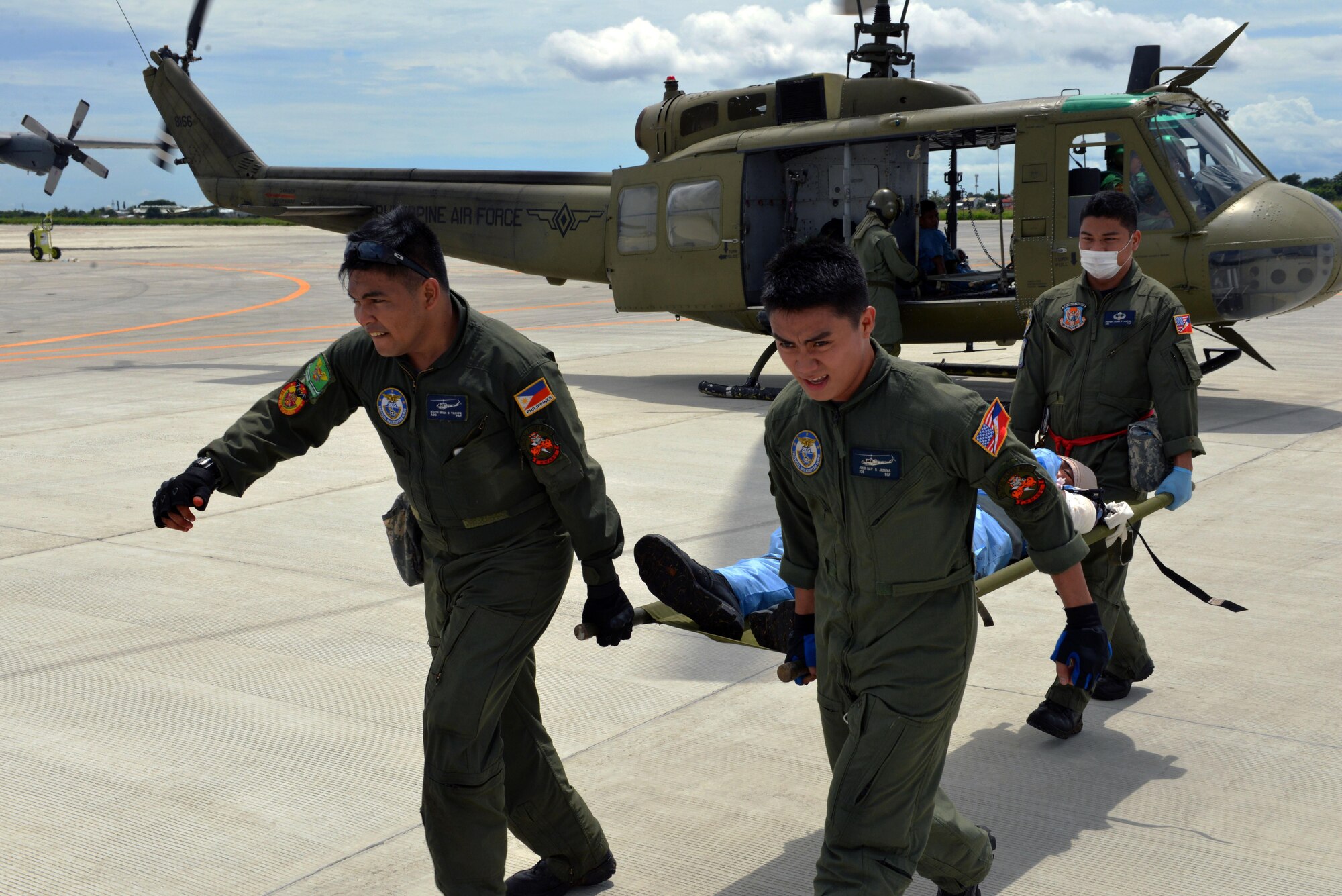 Philippine Air Force members carry a simulated patient toward a Philippine Air Force C-130 aircraft as part of a mass casualty response exercise during the current iteration of a rotational Air Contingent at Brigadier General Benito N Ebuen Air Base, Philippines, Sept. 29, 2016. The Air Contingent is helping build the capacity of the Philippine Air Force and increases joint training, promotes interoperability and provides greater and more transparent air and maritime situational awareness to ensure safety for military and civilian activities in international waters and airspace. Its missions include air and maritime domain awareness, personnel recovery, combating piracy, and assuring access to the air and maritime domains in accordance with international law. (U.S. Air Force photo by Capt. Mark Lazane)