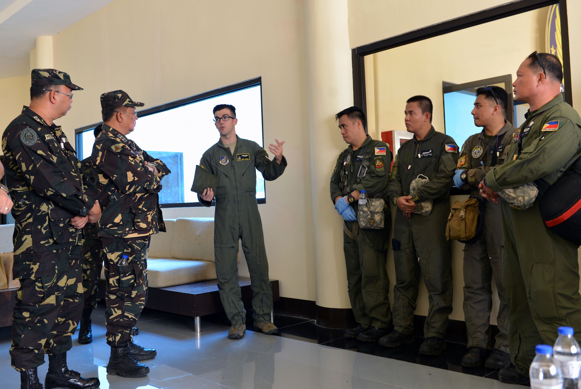 U.S. Air Force Senior Airman Joel Eicher (third from left), a loadmaster with the 36th Airlift Squadron, 374th Airlift Wing, Yokota, Japan, briefs Filipino military personnel prior to supporting patient care procedures during a mass casualty drill at Brigadier General Benito N Ebuen Air Base, Philippines Sept. 29, 2016. Two C-130 Hercules aircraft and crews from 374th Airlift Wing, Yokota Air Base, Japan, the 36th Contingency Response Group from Andersen Air Force Base, Guam, and other units from across U.S. Pacific Command conducted bilateral training missions and subject matter expert exchanges alongside their Philippine Air Force counterparts.  (U.S. Air Force photo by Capt. Mark Lazane)