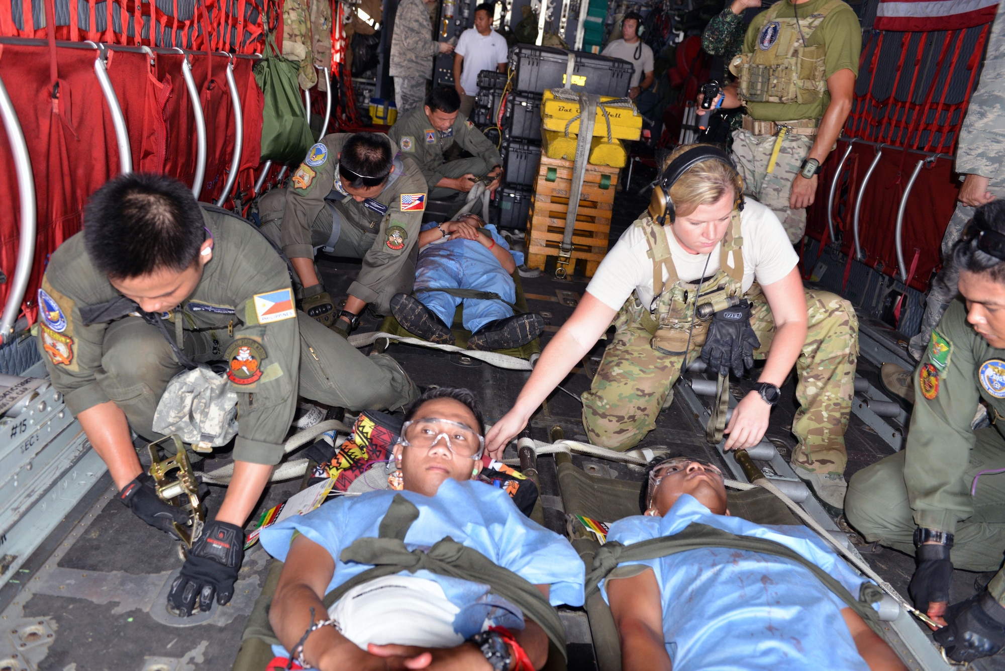 U.S. and Philippine Air Force members work together to rapidly secure patient litters in the midst of an engine running onload drill as part of a mass casualty response training exercise during the current iteration of a rotational Air Contingent at Brigadier General Benito N Ebuen Air Base, Philippines Sept. 29, 2016. The Air Contingent is helping build the capacity of the Philippine Air Force and increases joint training, promotes interoperability and provides greater and more transparent air and maritime situational awareness to ensure safety for military and civilian activities in international waters and airspace. Its missions include air and maritime domain awareness, personnel recovery, combating piracy, and assuring access to the air and maritime domains in accordance with international law. (U.S. Air Force photo by Capt. Mark Lazane)