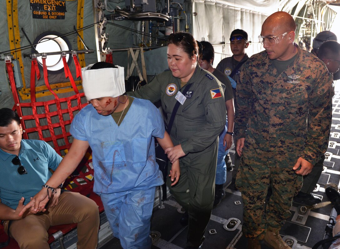 U.S. Navy Chief Petty Officer Mark Gaskins, a hospital corpsman (right), observes proper patient loading procedures during a civilian and military disaster response exercise as part of the current iteration of a rotational Air Contingent at Brigadier General Benito N Ebuen Air Base, Philippines Sept. 29, 2016. Two C-130 Hercules aircraft and crews from the 374th Airlift Wing, Yokota Air Base, Japan, the 36th Contingency Response Group from Andersen Air Force Base, Guam, and other units from across U.S. Pacific Command conducted bilateral training missions and subject matter expert exchanges alongside their Philippine Air Force counterparts. The Air Contingent is helping build the capacity of the Philippine Air Force and increases joint training, promotes interoperability and provides greater and more transparent air and maritime situational awareness to ensure safety for military and civilian activities in international waters and airspace. Its missions include air and maritime domain awareness, personnel recovery, combating piracy, and assuring access to the air and maritime domains in accordance with international law. (U.S. Air Force photo by Capt. Mark Lazane)