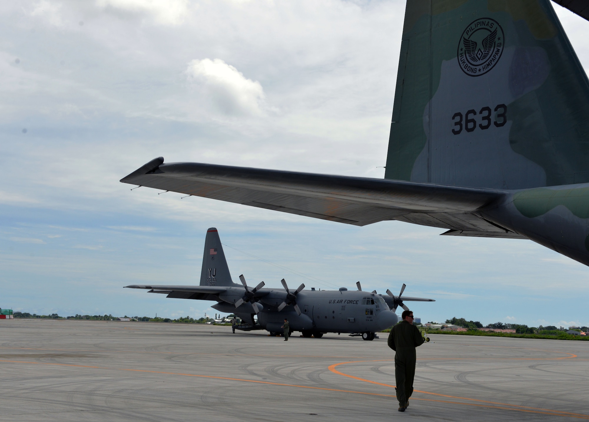 U.S. Air Force Capt. Mike Dzyndra, mission navigator, 36th Airlift Squadron, 374th Airlift Wing, Yokota Air Base, Japan, walks under the tail of a Philippine Air Force C-130 aircraft as a mass casualty response drill takes place during the rotational Air Contingent at Brigadier General Benito N Ebuen Air Base, Philippines, Sept. 29, 2016. The Air Contingent is helping build the capacity of the Philippine Air Force and increases joint training, promotes interoperability and provides greater and more transparent air and maritime situational awareness to ensure safety for military and civilian activities in international waters and airspace. Its missions include air and maritime domain awareness, personnel recovery, combating piracy, and assuring access to the air and maritime domains in accordance with international law. (U.S. Air Force photo by Capt. Mark Lazane)