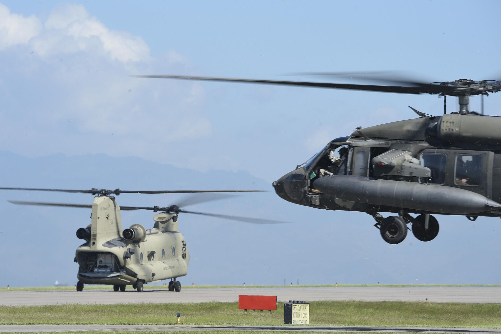 A UH-60 Blackhawk and a CH-47 Chinook helicopters assigned to Joint Task Force-Bravo’s 1st Battalion, 228th aviation regiment, prepare to launch from Soto Cano Air Base, Honduras, Oct. 4, 2016, to stage at the Grand Cayman Islands to provide airlift capabilities for Hurricane Matthew relief efforts if requested by the U.S. Agency for International Development’s Office of Foreign Disaster Assistance. The mission of Joint Task Force-Bravo includes being prepared to support disaster relief operations in Central America, South America and the Caribbean, when directed by SOUTHCOM. (U.S. Air Force photo by Staff Sgt. Siuta B. Ika)