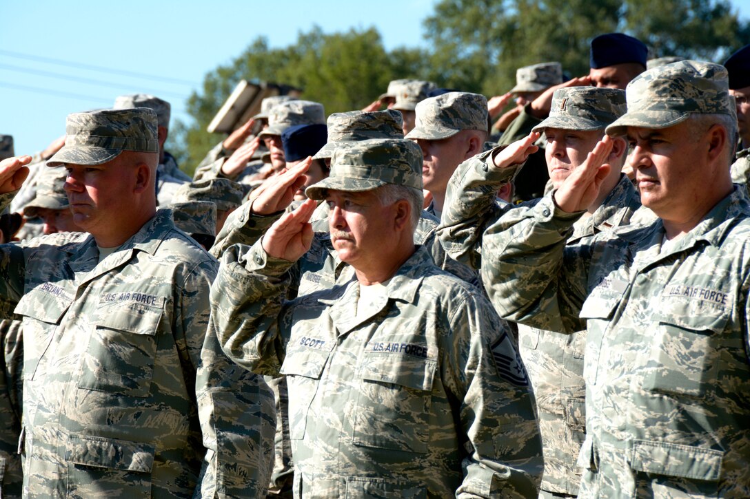 U.S. Air Force Airmen from the 145th Airlift Wing salute while “Taps” is played during the Annual Memorial Wall ceremony which memorializes deceased loved ones in front of family and friends at the North Carolina Air National Guard Base, Charlotte Douglas Int’l. Airport, Oct. 2, 2016. Additional names of members who’ve passed are memorialized each year as a lasting tribute to those individuals who have helped establish the proud tradition upon which the NCANG is built. (U.S. Air National Guard photo by Staff Sgt. Laura Montgomery)