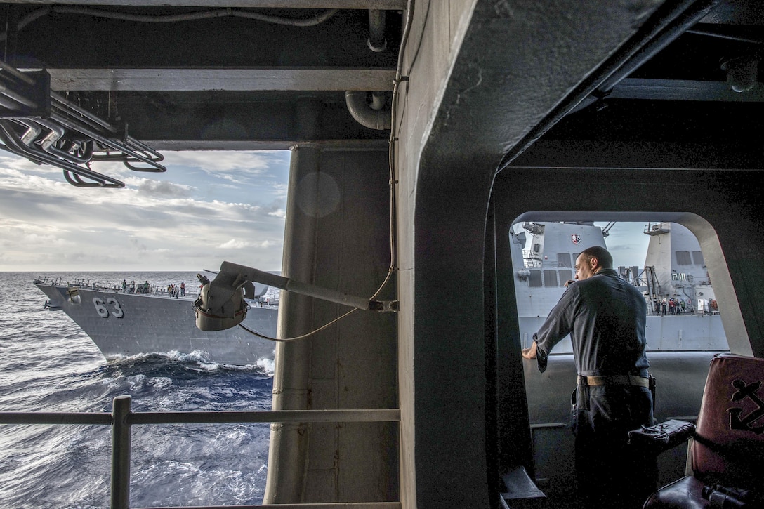 Navy Lt. Cmdr. Todd Kamins relays radio communications on the USS Ronald Reagon during a refueling with USS Stethem in the Philippine Sea, Oct. 2, 2016. The Reagan is supporting security and stability in the Indo-Asia-Pacific region. Navy photo by Petty Officer 3rd Class Nathan Burke