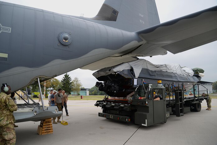 Loadmasters and crew chiefs from the 67th Special Operations Squadron guide a Rigid Inflatable Boat as it’s loaded onto an MC-130J Commando II in preparation for a Maritime Craft Aerial Delivery drop Sept. 26, 2016, at Stuttgart Air Base, Germany. Two of three MC-130J Commando IIs from the 67th SOS were loaded for MCADS drops in participation with the 2016 Night Hawk exercise. (U.S. Air Force photo by Senior Airman Justine Rho)