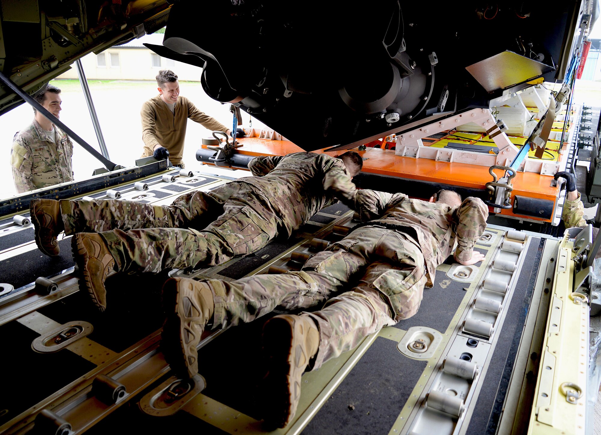 Loadmasters from the 67th Special Operations Squadron double check alignment while loading a Rigid Inflatable Boat onto an MC-130J Commando II in preparation for a Maritime Craft Aerial Delivery drop Sept. 26, 2016, at Stuttgart Air Base, Germany. The MCADS is the only airdrop system currently capable of deploying RIBs. The RIB is loaded onto the aircraft on a platform that must be carefully aligned due to the sheer size of the cargo. (U.S. Air Force photo by Senior Airman Justine Rho)