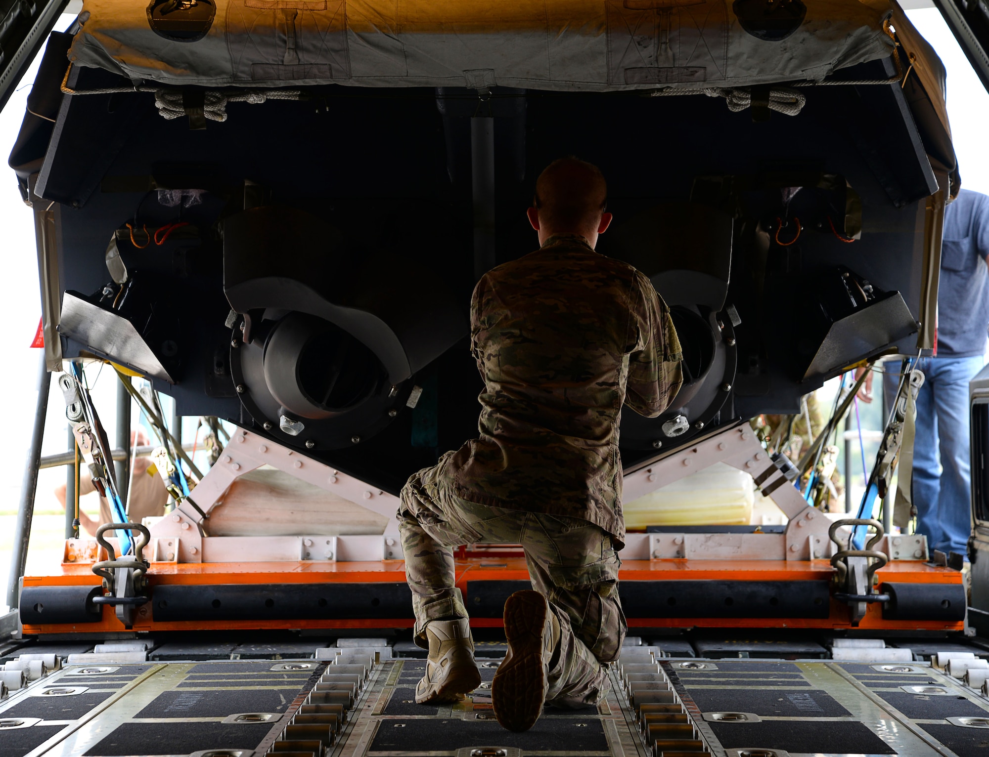 A U.S. Air Force MC-130J Commando II loadmaster, assigned to the 67th Special Operations Squadron makes guidance calls to load a Rigid Inflatable Boat onto an MC-130J Commando II in preparation for a Maritime Craft Aerial Delivery drop Sept. 26, 2016, at Stuttgart Air Base, Germany. The MCADS is the only airdrop system currently capable of deploying RIBs. The RIB is loaded onto the aircraft on a platform that must be carefully aligned due to the sheer size of the cargo. (U.S. Air Force photo by Senior Airman Justine Rho)