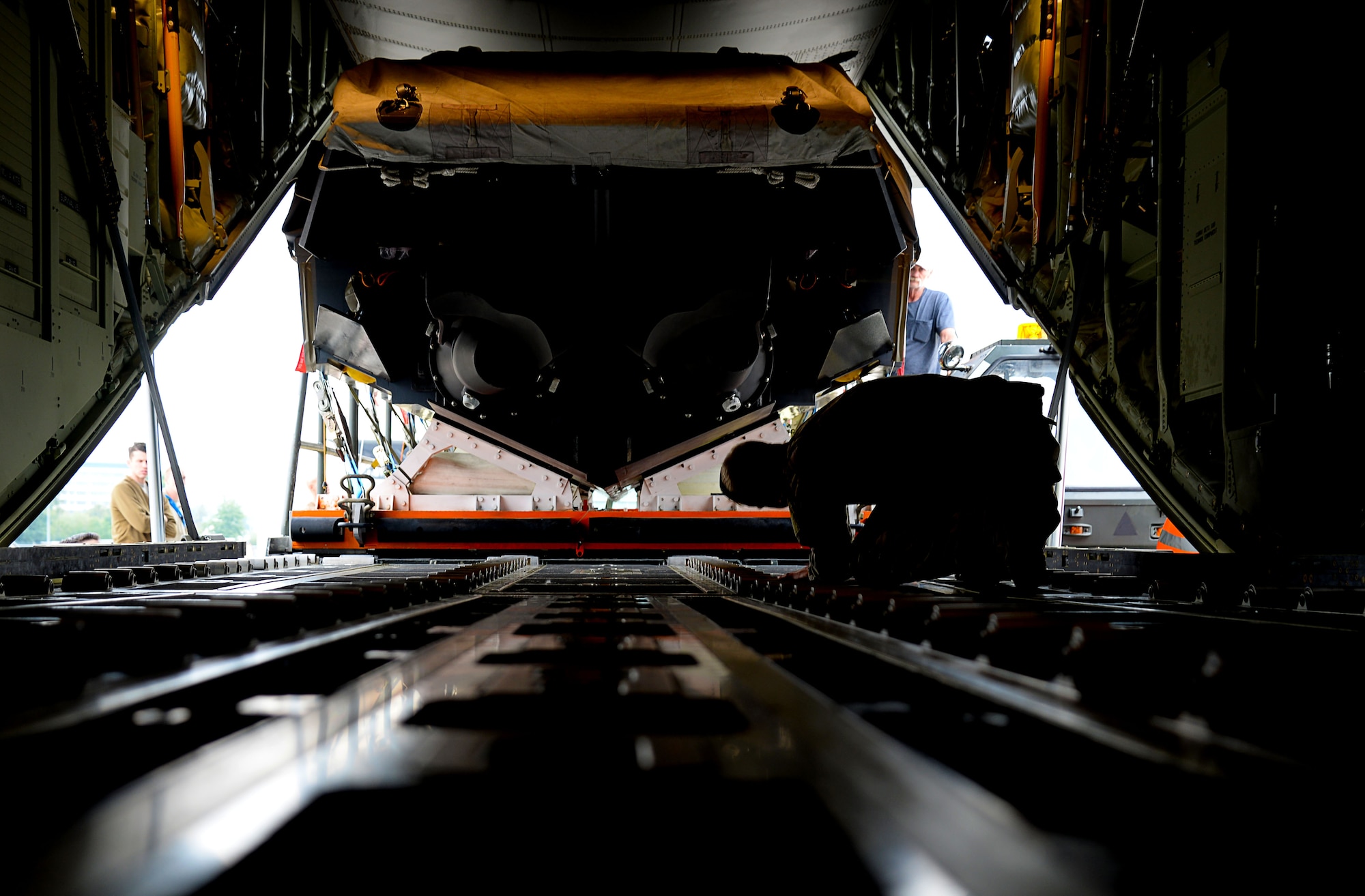 A U.S. Air Force MC-130J Commando II loadmaster, assigned to the 67th Special Operations Squadron makes guidance calls to load a Rigid Inflatable Boat onto an MC-130J Commando II in preparation for a Maritime Craft Aerial Delivery drop Sept. 26, 2016, at Stuttgart Air Base, Germany. The MCADS is the only airdrop system currently capable of deploying RIBs. The RIB is loaded onto the aircraft on a platform that must be carefully aligned due to the sheer size of the cargo. (U.S. Air Force photo by Senior Airman Justine Rho)