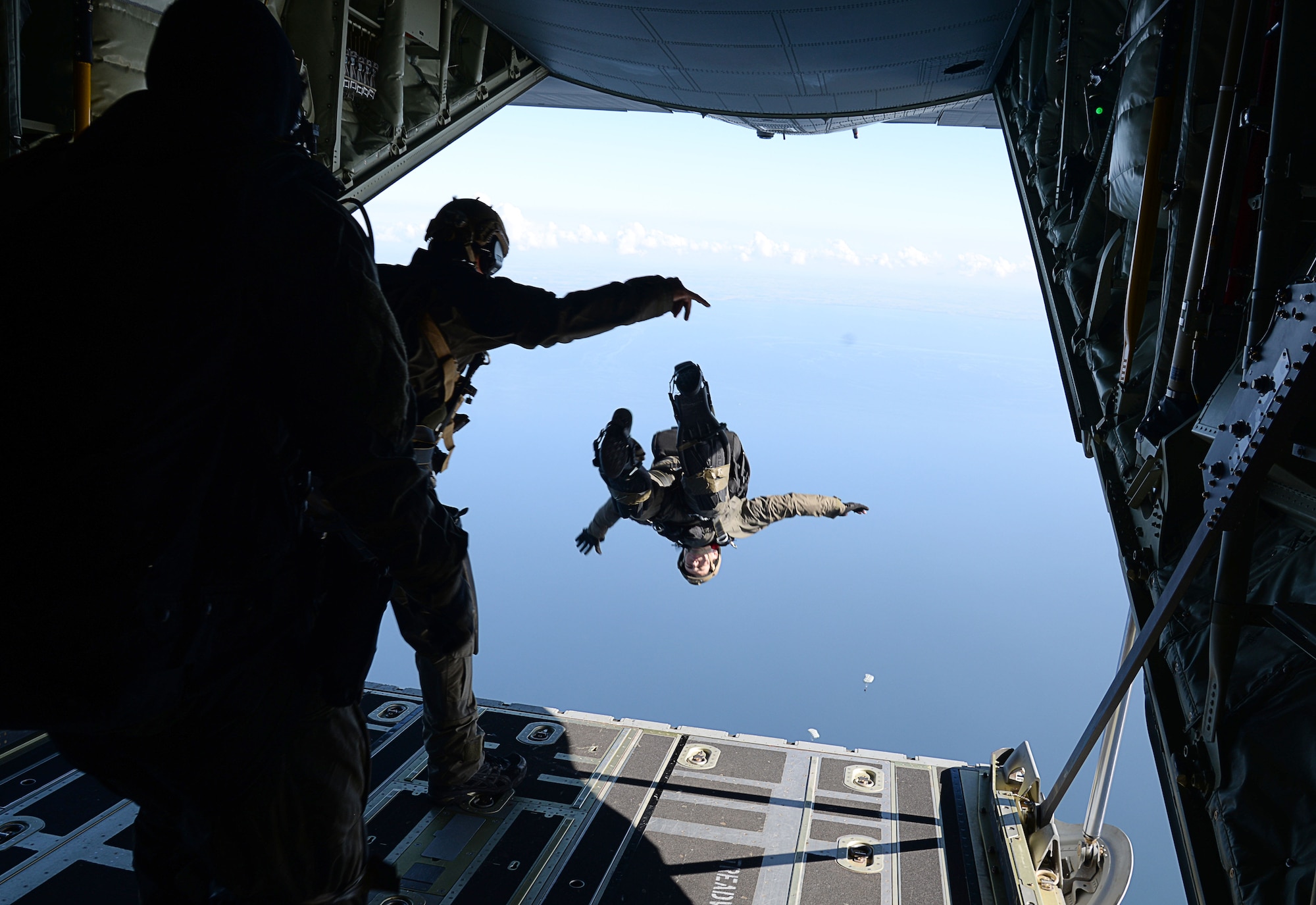 A U.S. Air Force Air Commando assigned to the 352nd Special Operations Wing conducts a free fall from an MC-130J Commando II assigned to the 67th Special Operations Squadron, over the Little Belt Strait in Denmark Sept. 27, 2016. Airmen from RAF Mildenhall, England and U.S. Navy Special Warfare Combatant-Craft crewmen worked with Danish air commandos during the 2016 Night Hawk exercise testing joint force capabilities. (U.S. Air Force photo by Senior Airman Justine Rho)