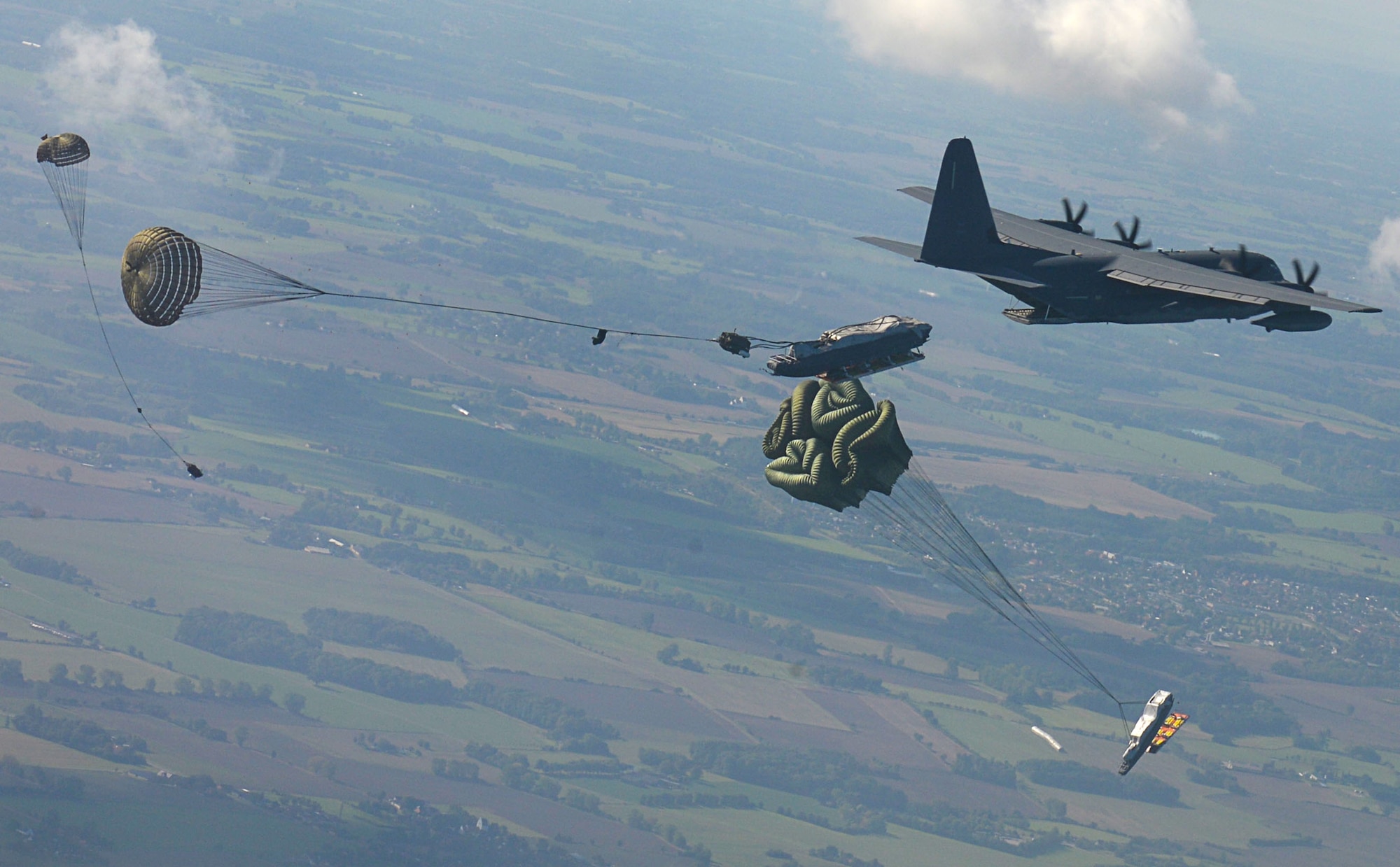 A U.S. Air Force MC-130J Commando II performs a Maritime Craft Aerial Delivery System drop over the Little Belt Strait in Denmark Sept. 27, 2016. After the Rigid inflatable Boats were deployed, U.S. Navy Special Warfare Combatant-Craft crewmen followed to set up the equipment. Finally, a third aircraft off loaded U.S. Air Force and Danish air commandos at the drop zone. (U.S. Air Force photo by Senior Airman Justine Rho)