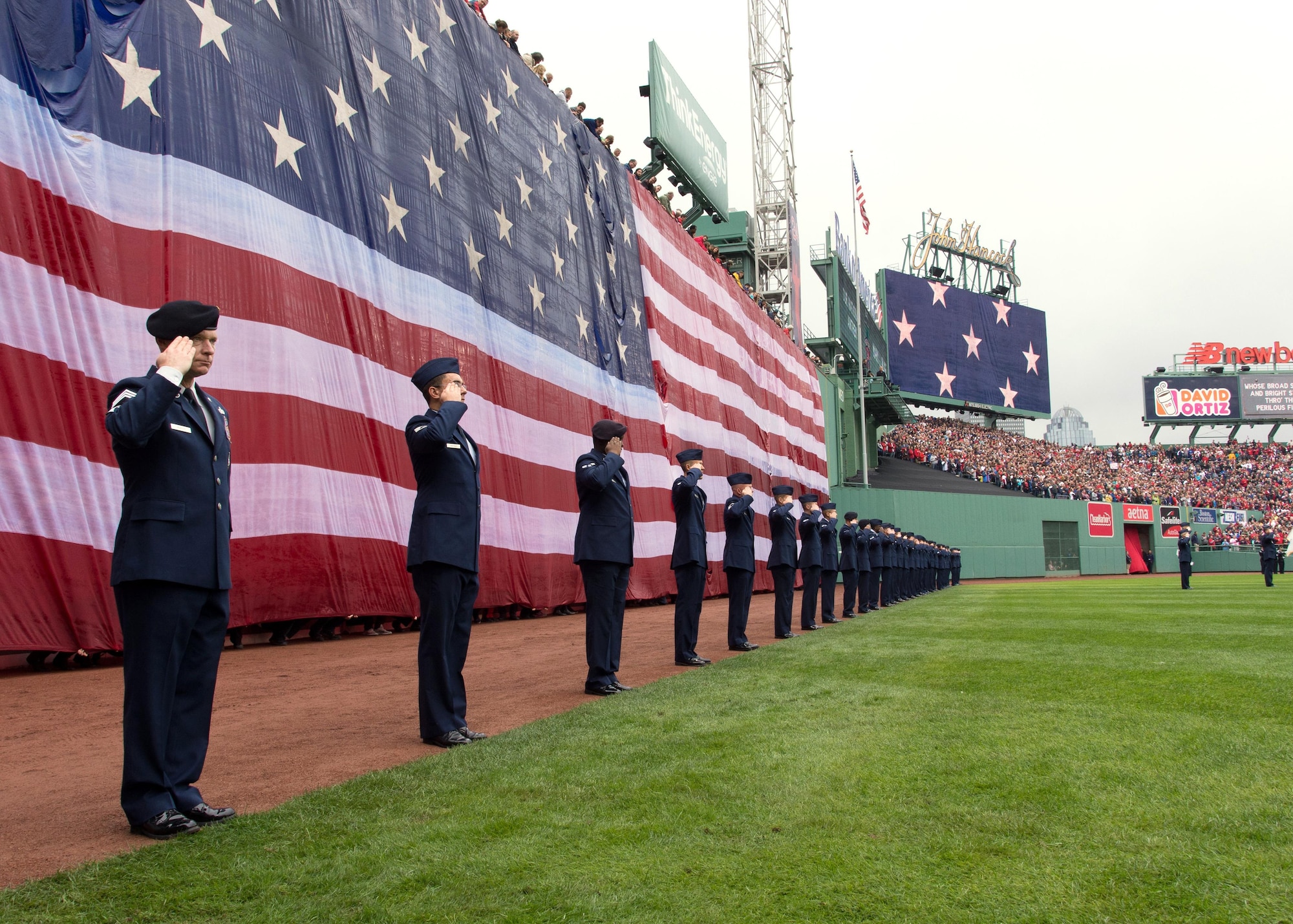 More than 30 Airmen from Hanscom Air Force Base, Mass., salute while the national anthem is played prior to a Boston Red Sox game at Fenway Park Oct. 2. Airmen participated in the flag detail as part of pregame festivities during the team's final regular season game. (U.S. Air Force photo by Mark Herlihy) 